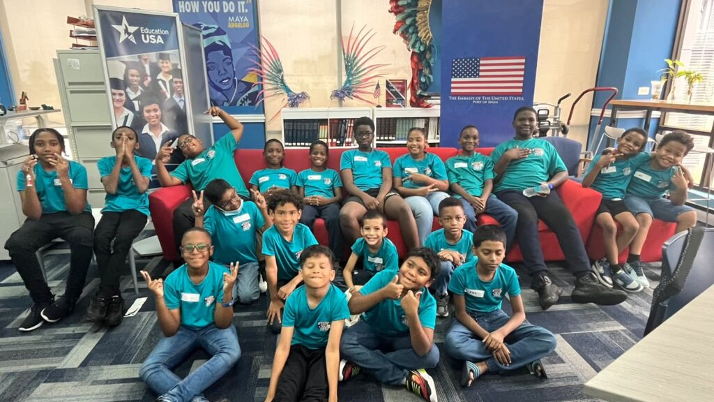 Students at Rent My Tutor STEM Academy's Cycle 1 STEM Robotics Summer Camp 2026 smile and give thumbs up while participating in hands-on STEM learning at the American Center, U.S. Embassy, St. Clair, Trinidad and Tobago.